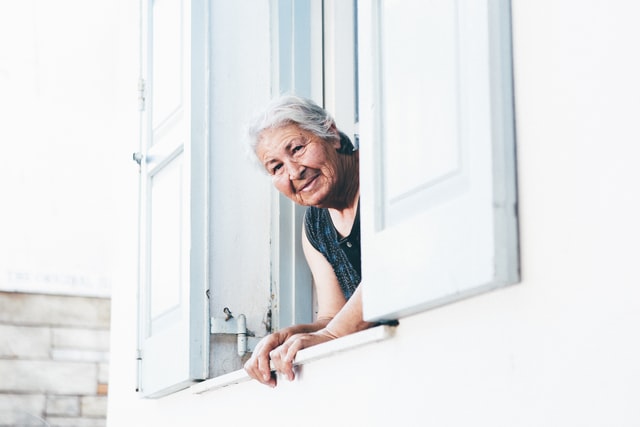 old person looking out the window